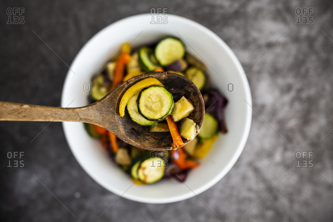 Mix of cooked vegetables in bowl- on spoon- close-up