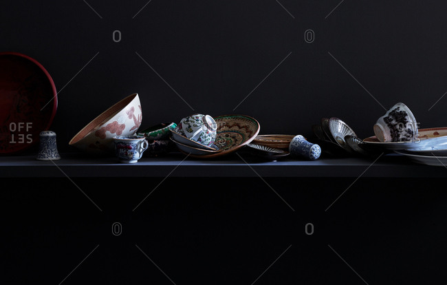 Variety of dishes strewn upon a shelf