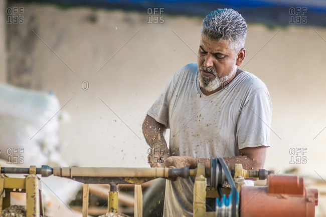 Man using woodworking machine at workplace