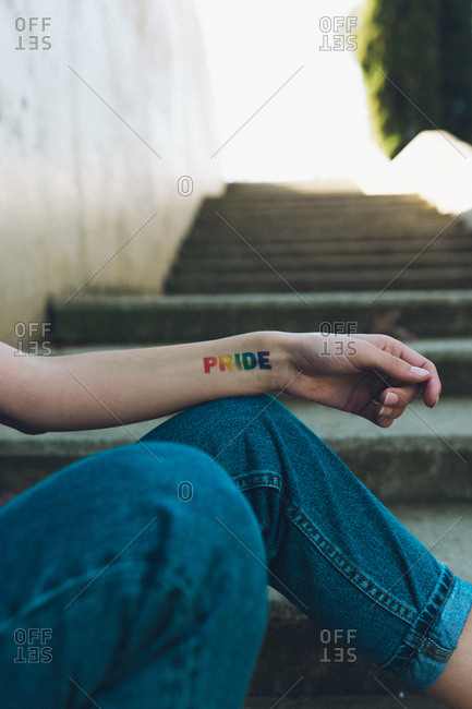 Bisexual girl with gay pride tattoo on her arm