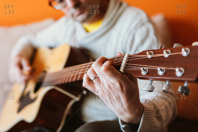 Detail of a man playing the guitar