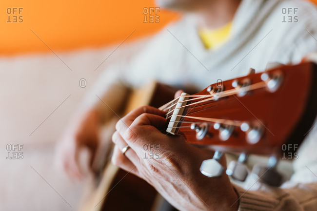 Detail of a man playing the guitar