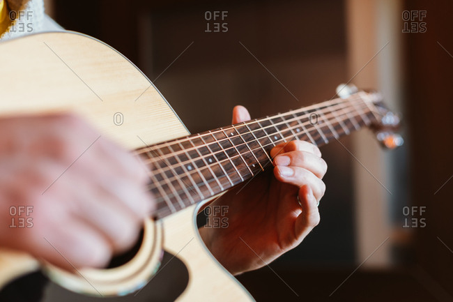 Detail of a man playing the guitar