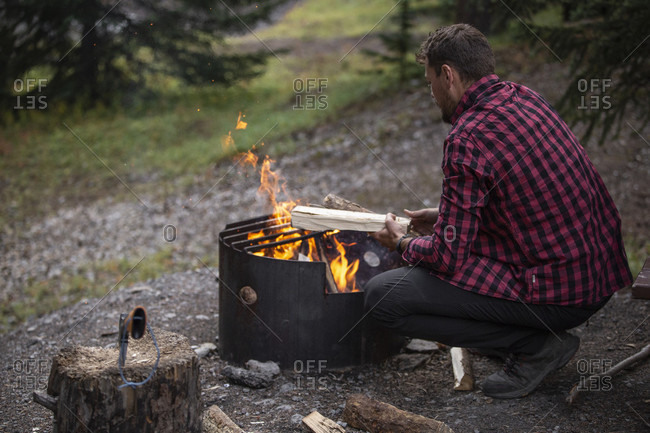 September 6, 2018: Canada, Alberta, Canadian Rockies, Jasper National Park, Wilcox Creek Campground, man at fire place