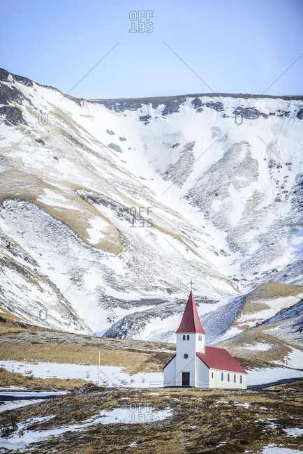 Church under snowy mountains in rural landscape, Vik, Iceland