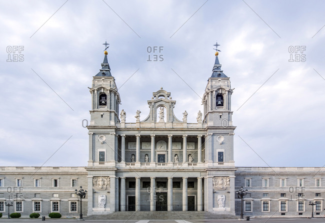 Ornate cathedral and cloudy sky, Madrid, Spain