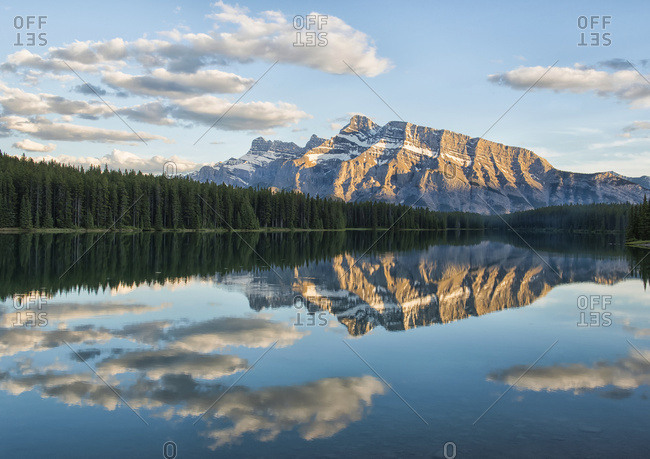 View of the back of Mount Rundle reflected in the water of Two Jack Lake, Banff National Park; Banff, Alberta, Canada