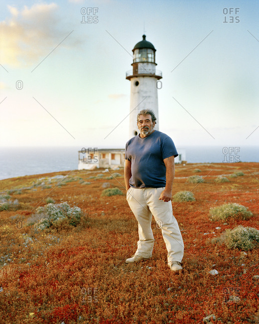 MEXICO, Baja,  - March 20, 2017: portrait of lighthouse keeper standing in front of lighthouse, San Benitos Islands