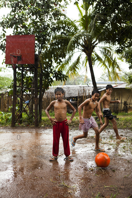PHILIPPINES, Palawan, Puerto Princesa,  - February 5, 2011: Ian, Marvin and Nestor play basketball on Abanico Road in Barangay Village, San Pedro