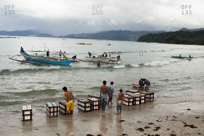 PHILIPPINES, Palawan, Sabang,  - February 8, 2011: boats drop supplies on the main beach in the town of Sabang