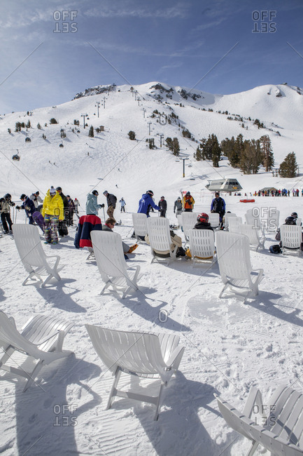 USA, California, Mammoth,  - March 5, 2011: several skiers and snowboarders rest at the bottom of the chairlift at Mammoth Ski Resort