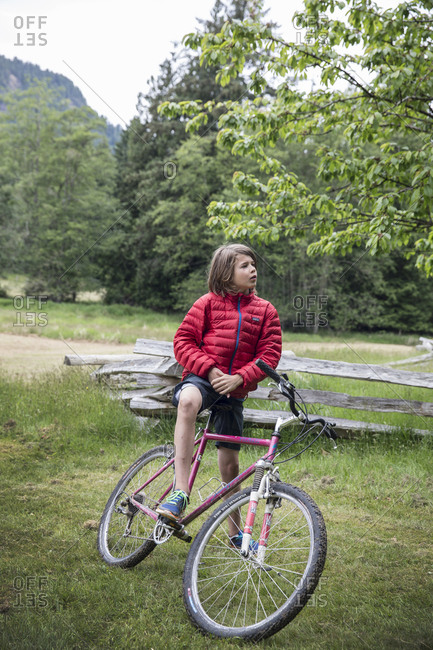 CANADA, Vancouver, British Columbia,  - May 26, 2013: boy stands stands with his bike on Gambier Island, in the Howe Sound