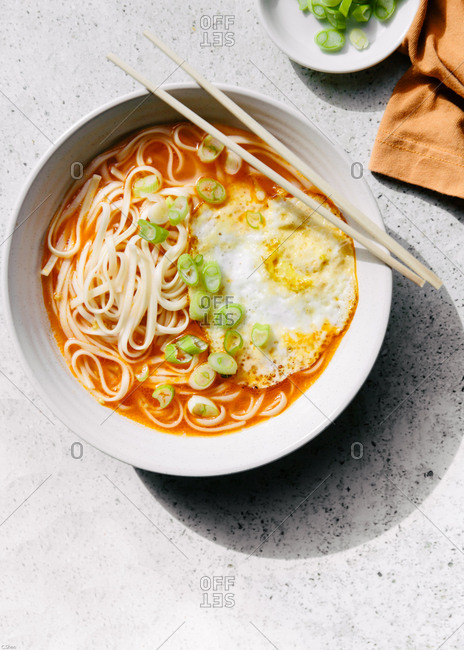 Overhead view of tomato noodle soup with egg