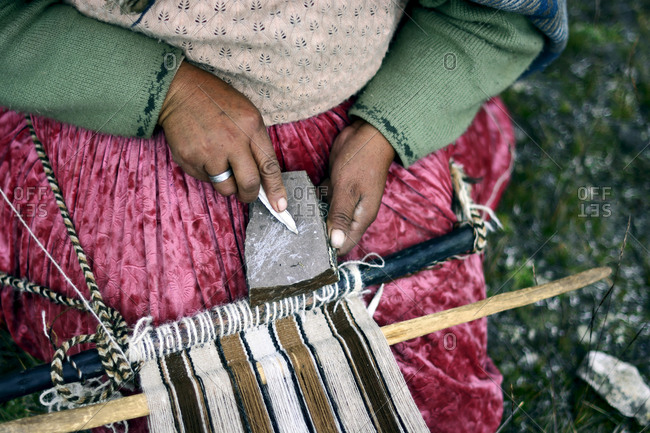 Aymara artisan woman weaving with wool
