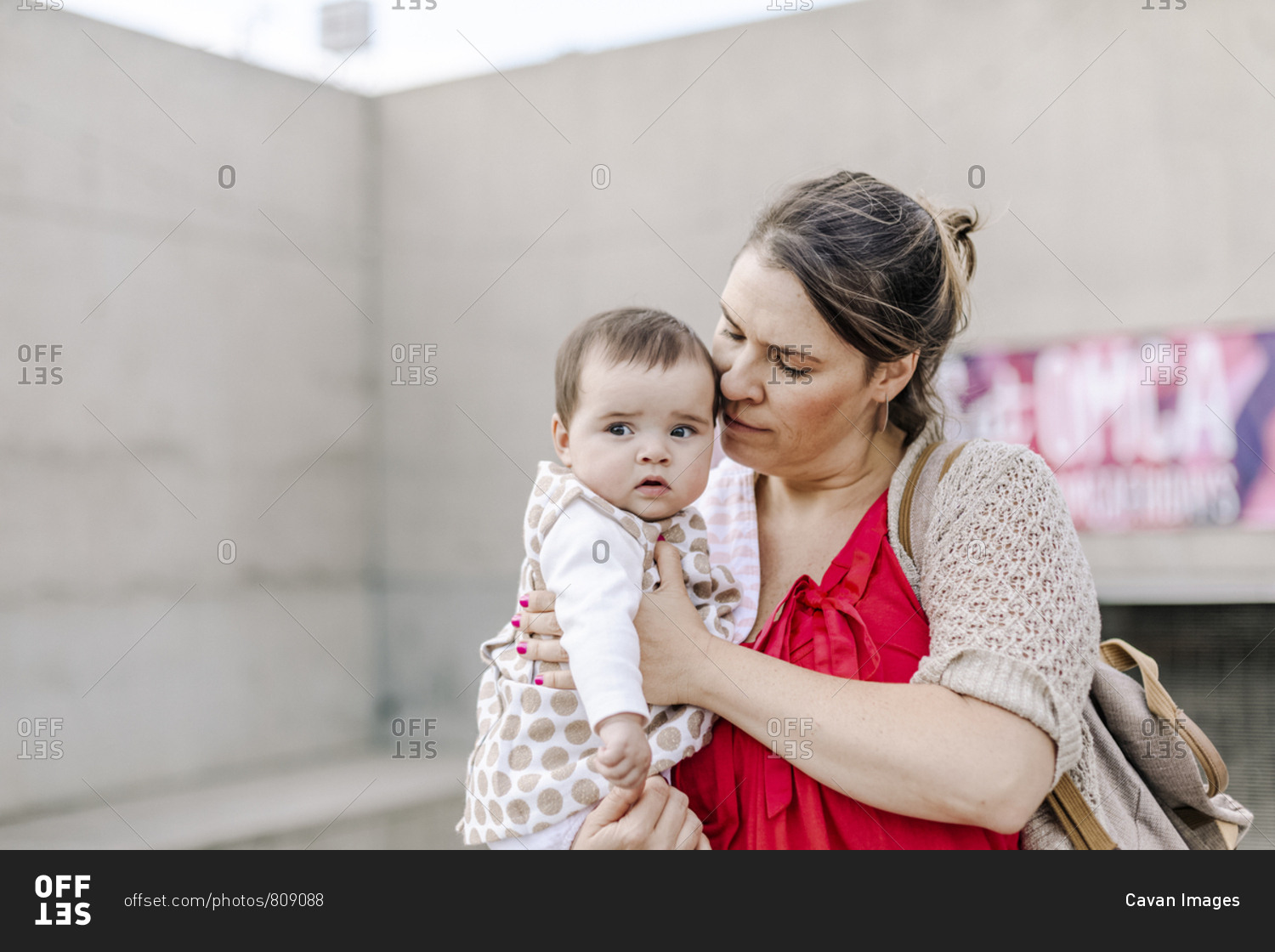Mother holding and comforting baby outdoor