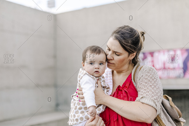 Mother holding and comforting baby outdoor