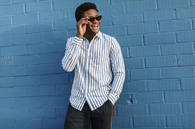 Portrait of a stylish black man wearing blue striped collared shirt