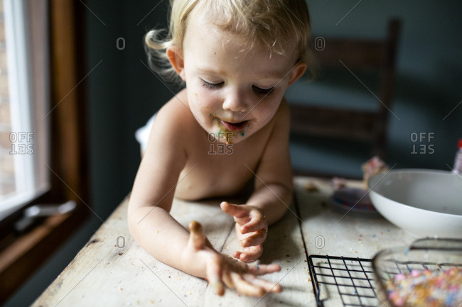 Happy toddler girl with messy sticky face and hands