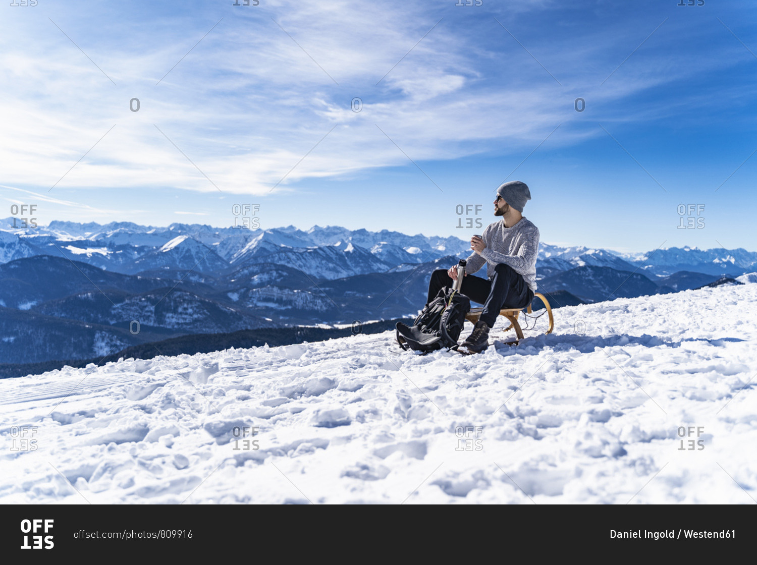 Germany- Bavaria- Brauneck- man in winter in the mountains having a break