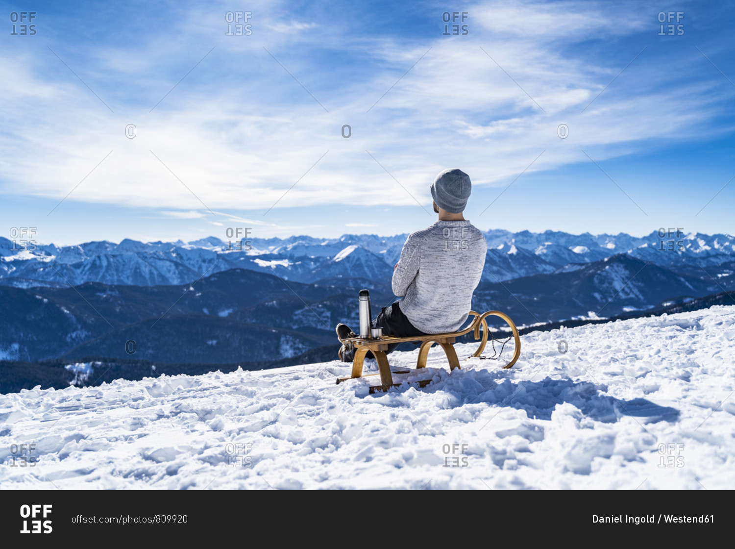 Germany- Bavaria- Brauneck- man in winter in the mountains having a break
