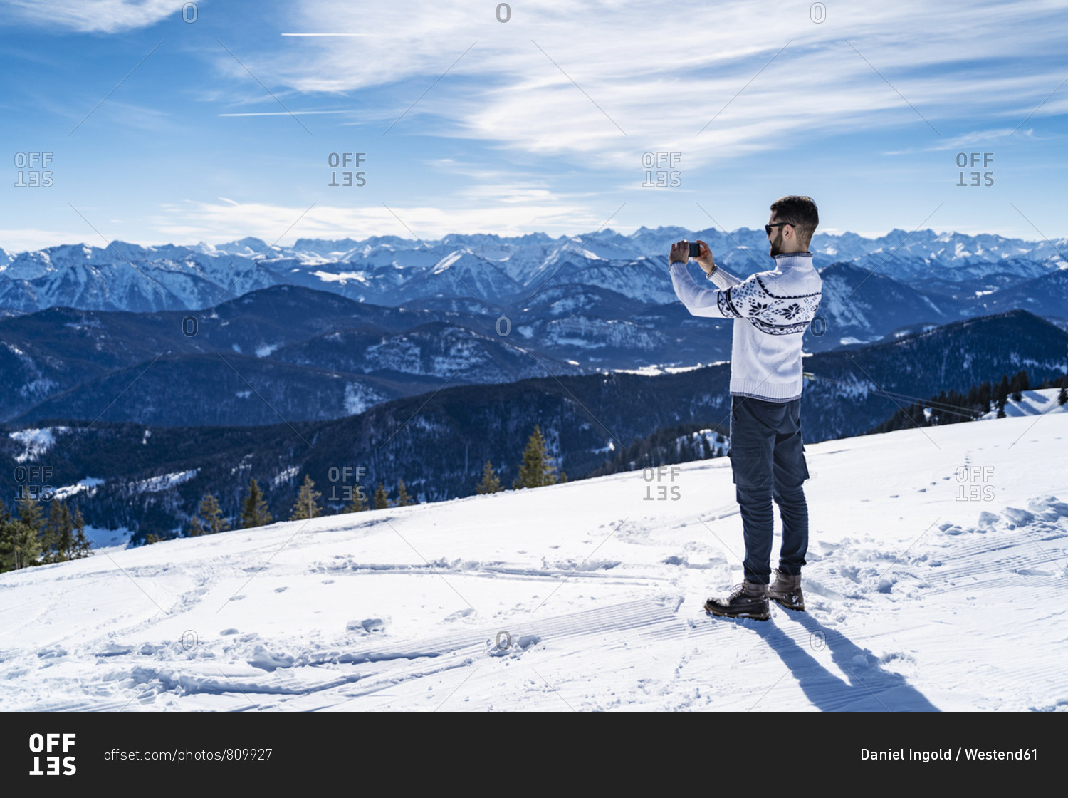 Germany- Bavaria- Brauneck- man in winter in the mountains taking a picture