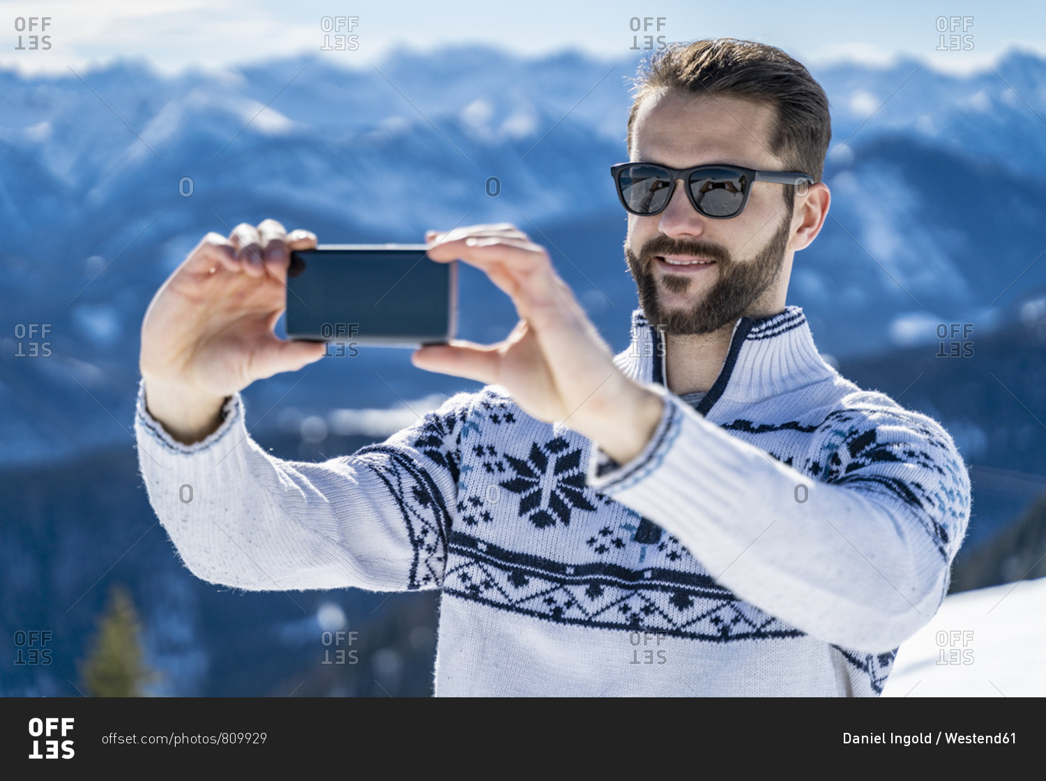 Germany- Bavaria- Brauneck- man in winter in the mountains taking a selfie