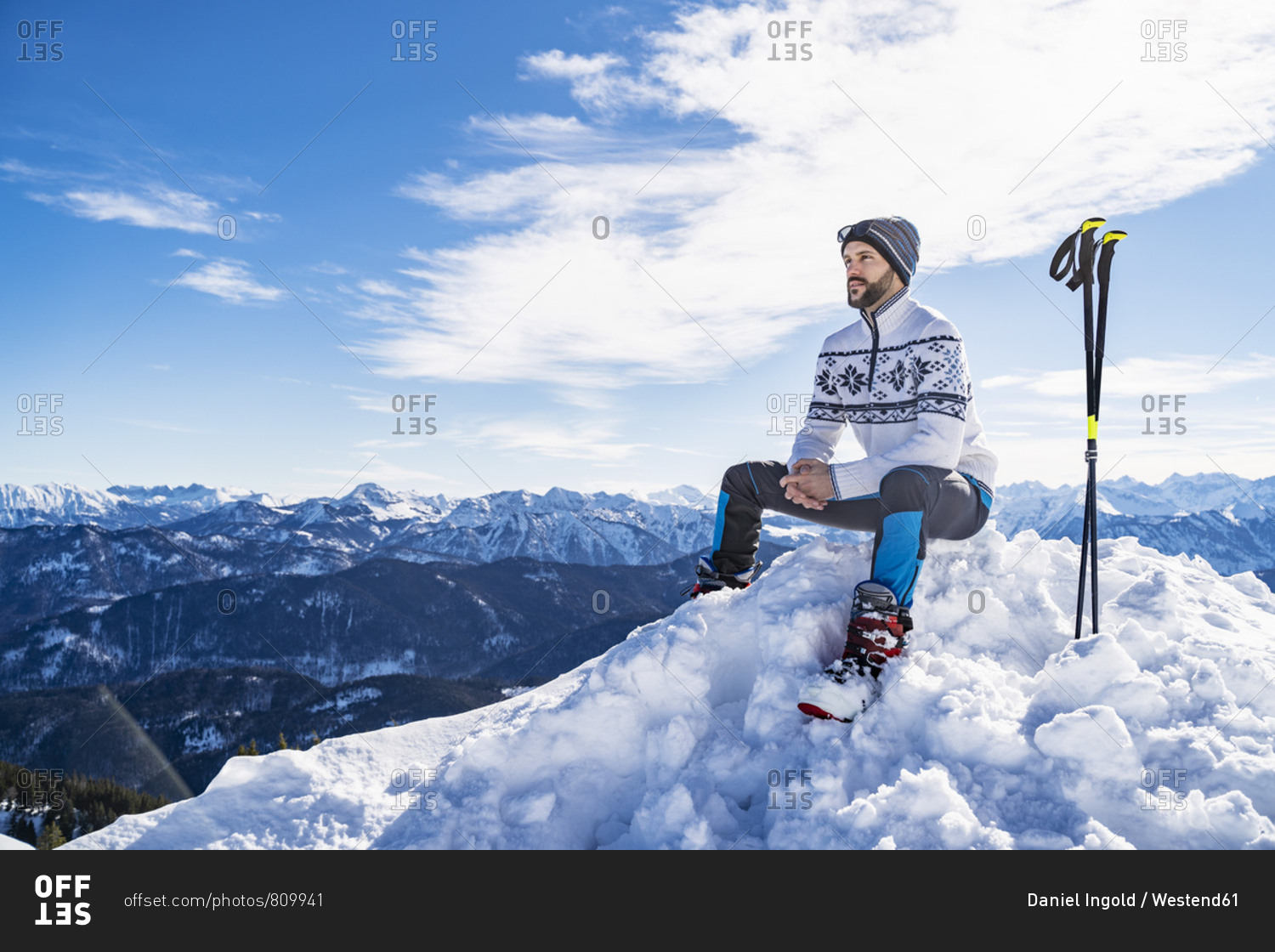 Germany- Bavaria- Brauneck- man in winter sitting on mountaintop