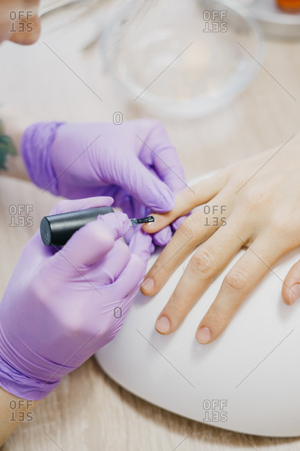 Close up of woman hands making manicure to a client at the salon. beauty services, beauty, health care