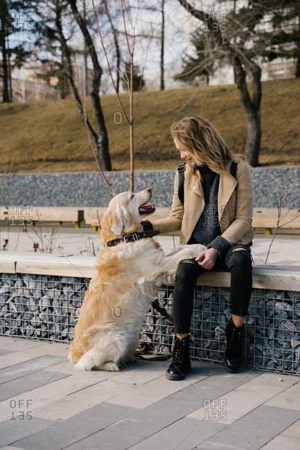The woman lovingly hugging his dog Golden Retriever