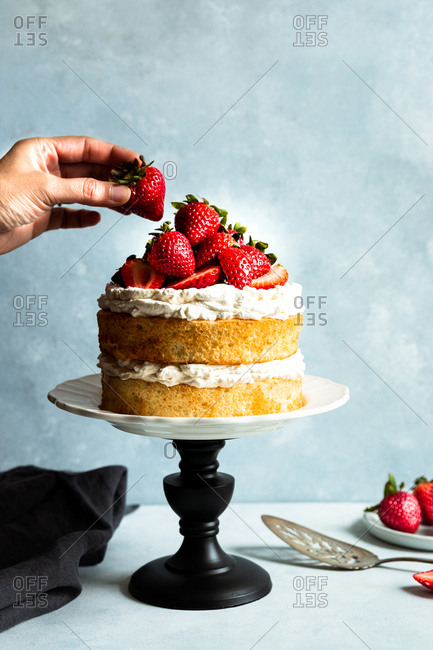Strawberry vanilla cream cake with strawberries on a stand