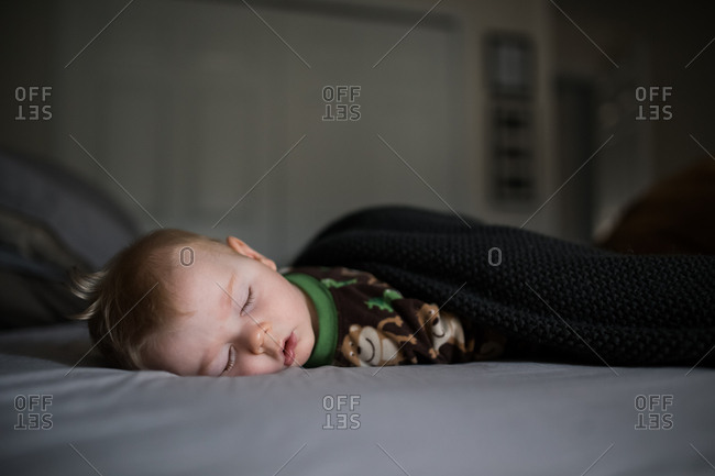 Newborn baby boy sleeping on a blanket stock photo - OFFSET