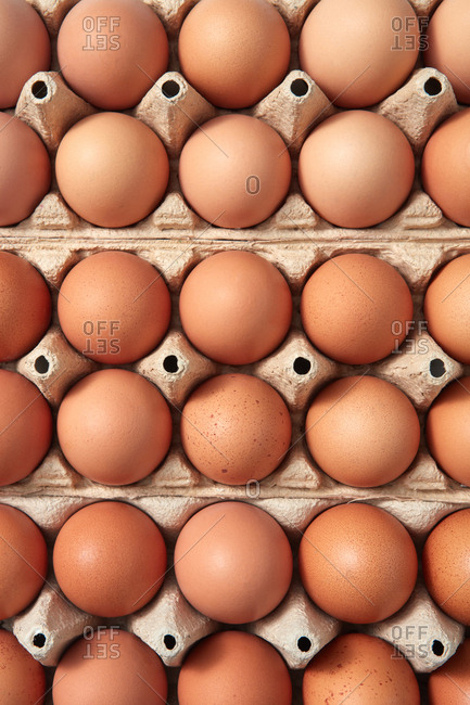Set of brown eggs in a carton box. Background food. Easter concept. Flat lay