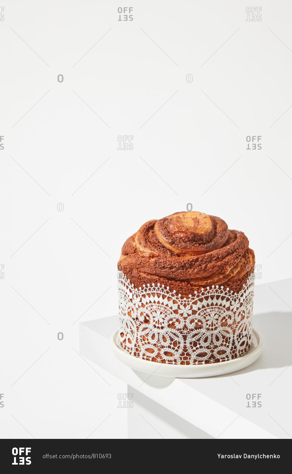 The composition of the fresh Easter cake, with beautiful lace on a bright table around a white background with space for text. Traditional easter dessert