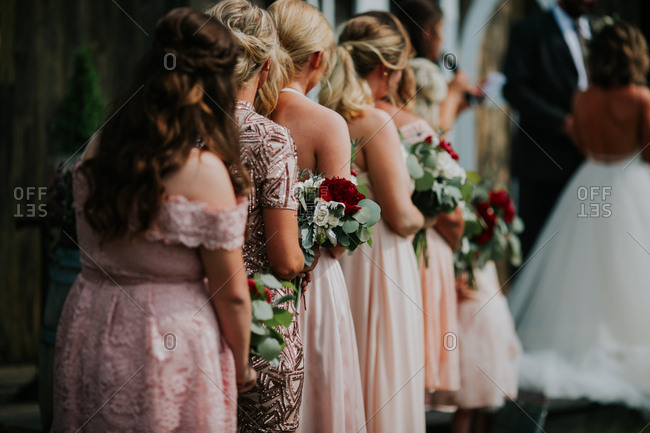 Young girls helping bride with her dress