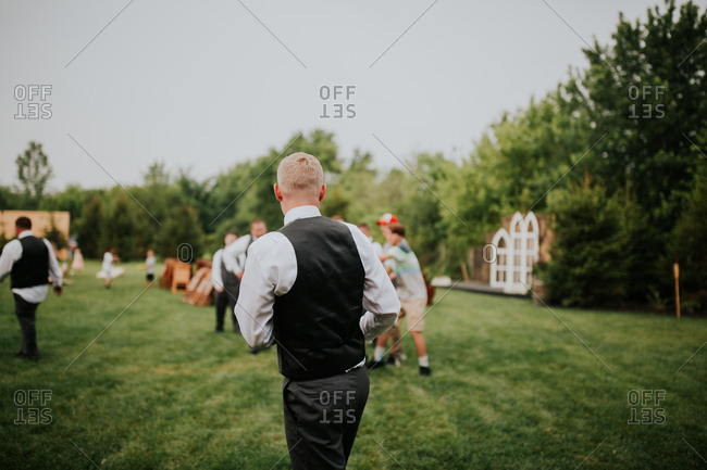 Bride throwing bouquet at wedding