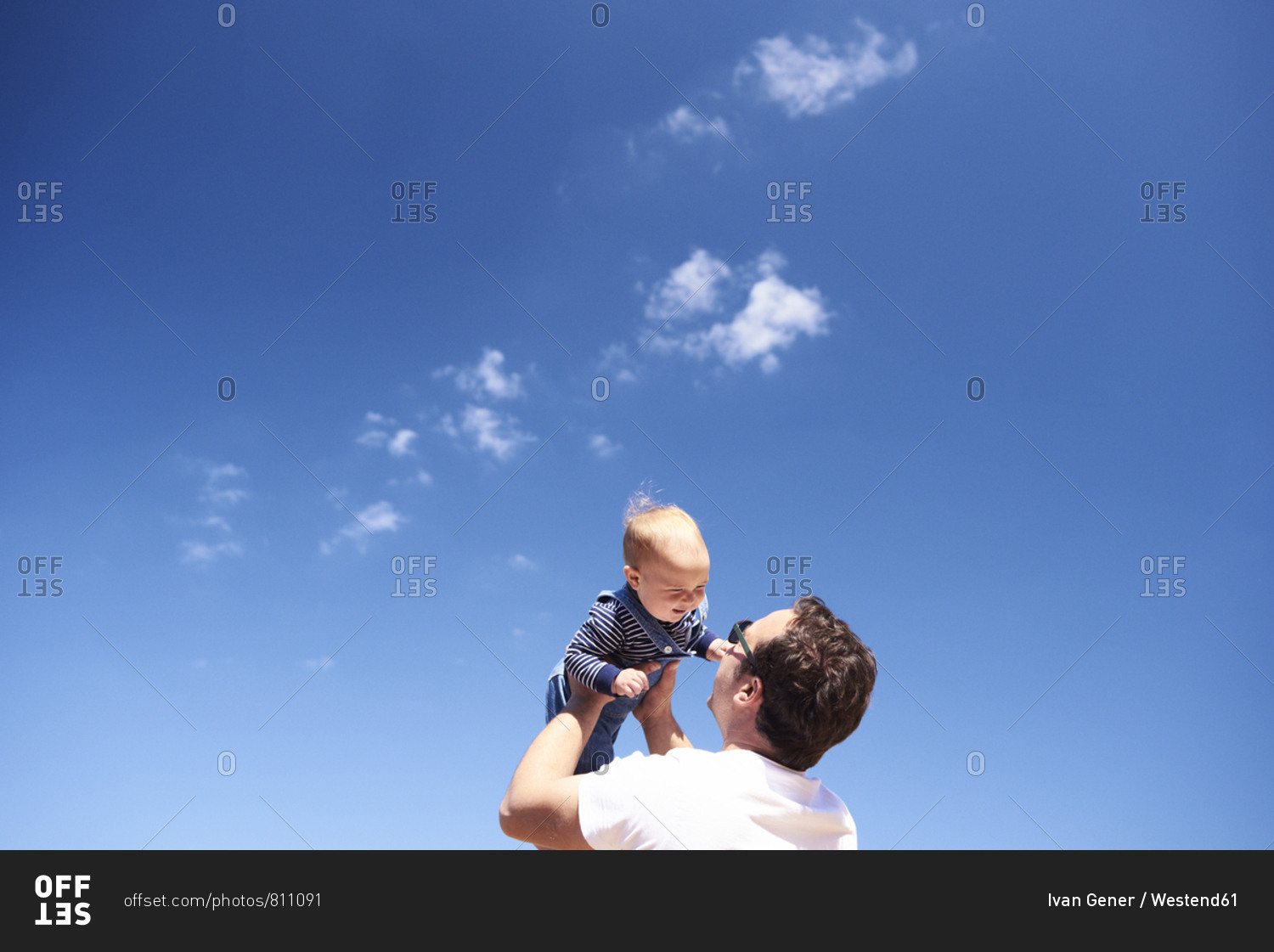Father playing with little son on the beach