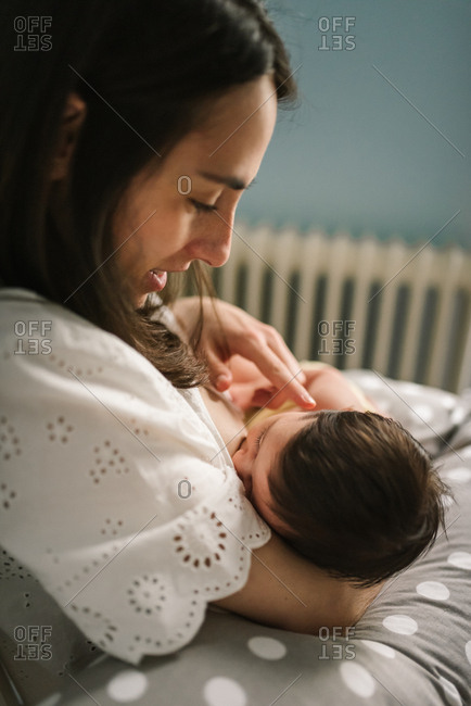 Mother feeding baby at home