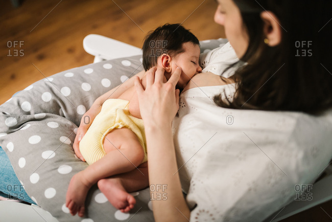 Mother feeding baby at home