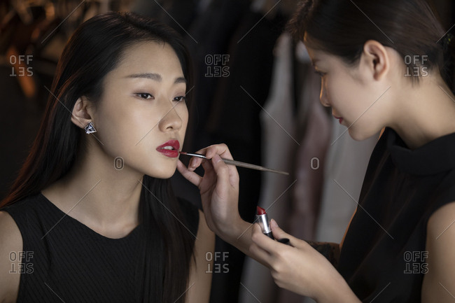 Makeup artist applying makeup on model