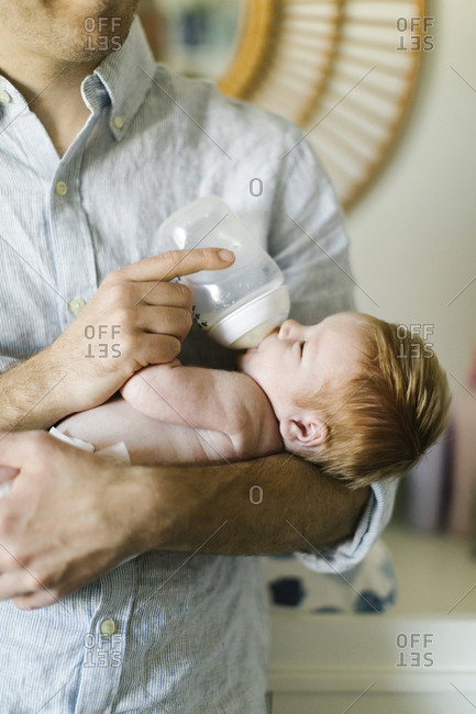 Man feeding his newborn son