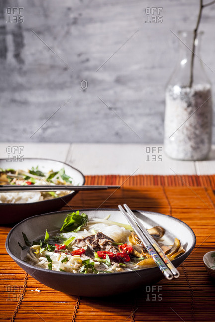 Vietnamese rice noodle soup with mushrooms and beef