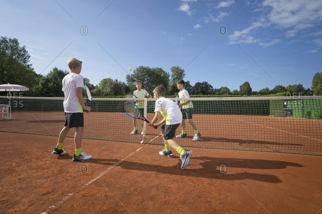 Young boys playing tennis, Bavaria, Germany