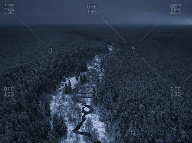 Aerial view of a river in the snowy landscape in Estonia.