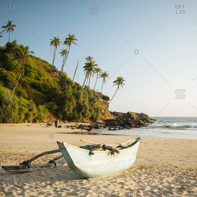 January 4, 2019: Traditional wooden boat on Talalla Beach at dusk, South Coast, Sri Lanka, Asia