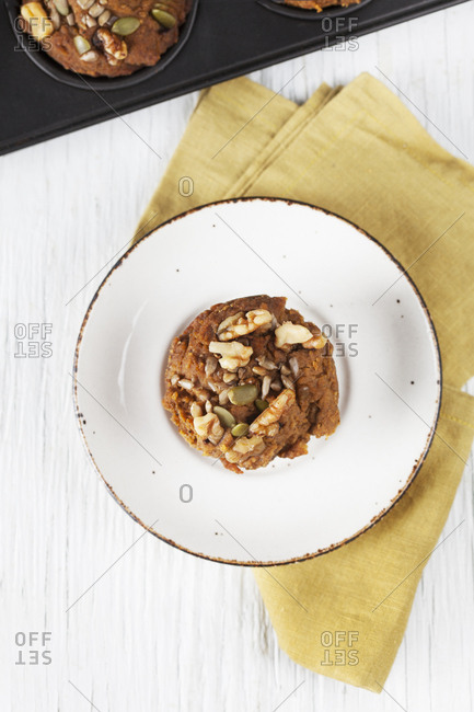 Overhead view of a fresh  apple muffin on a plate with muffin tin