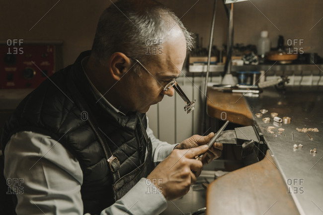 Artisan making jewelry in his workshop
