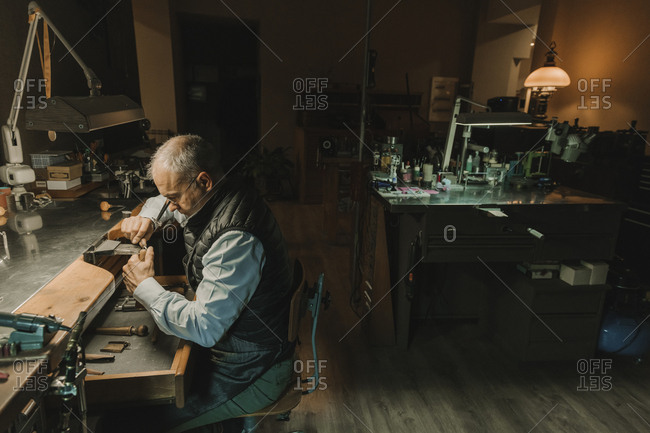 Artisan making jewelry in his workshop