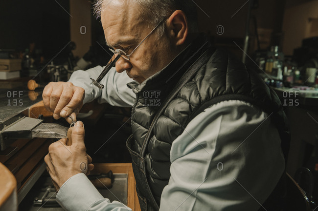 Artisan making jewelry in his workshop