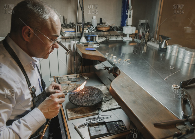 Artisan making jewelry in his workshop
