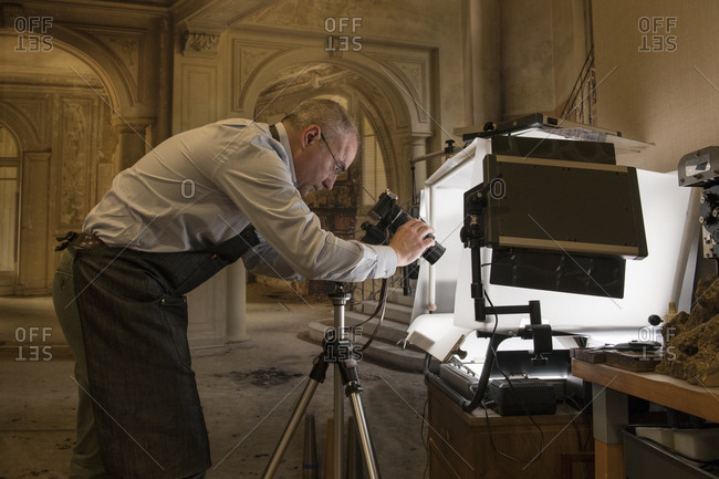 Artisan goldsmith taking pictures of a ring
